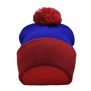 Close-up of winter knit beanie with thick texture and red pom-pom decoration