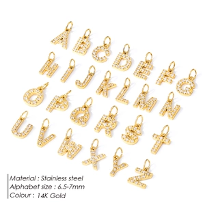 Detailed view of 26 letters A-Z charms in 14K gold plated stainless steel with zircon stones