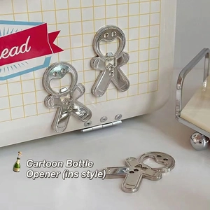 Set of three gingerbread man stainless steel bottle openers with magnetic fridge attachment