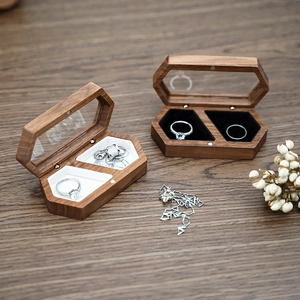 Macro view of walnut wood jewelry boxes with glass lids and velvet lining slots