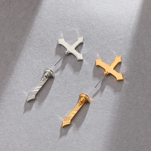 Detail showing gothic sword stud earring with red blood drip accent on grey surface
