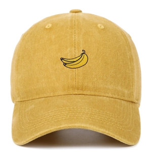 Detailed close-up of yellow washed cotton baseball cap with banana fruit embroidery