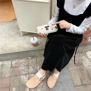 Outdoor shot of an off-white plush pencil case with cute bear embroidery and woven label