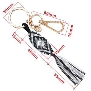 Ethnic woven keychain with evil eye diamond pattern, gold ring, and long tassel accents