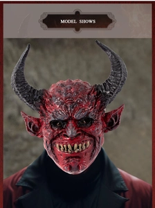 Detail shot of a red devil latex mask featuring black horns, sharp teeth and facial textures