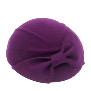 Close-up of a purple wool beret with a large decorative bow for an elegant retro look