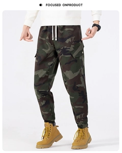 Detail of men's camouflage cargo pants showing elastic drawstring waist and side pockets