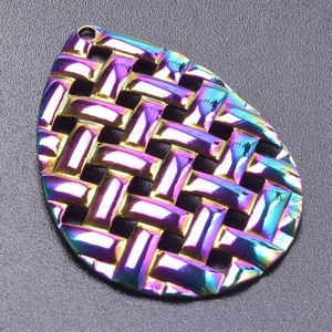 Macro shot of 18k rainbow plated stainless steel teardrop pendant with woven texture