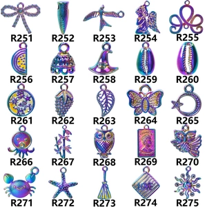 Macro view of assorted iridescent laser-cut owl and butterfly charm pendants in grid layout