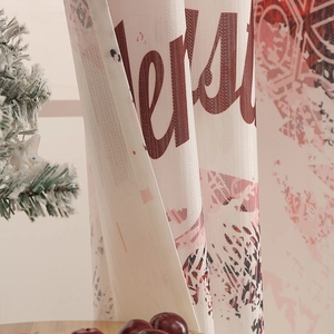 Close-up of Merry Christmas print on festive canvas fabric with snowflake details