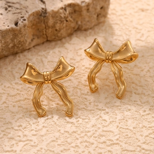 Gros plan de boucles d'oreilles nœud en acier inoxydable plaqué or 18 carats poli