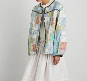 Detailed view of women's patchwork quilted cotton jacket featuring colorful floral patterns