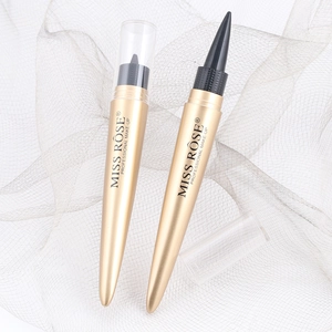 Detailed close-up of two golden MISS ROSE professional eyeliners on soft mesh fabric