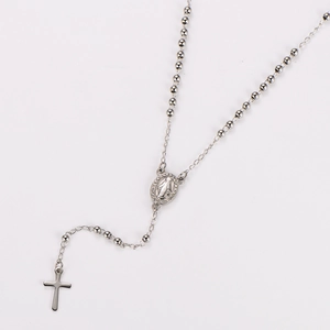 Detailed view of silver stainless steel rosary necklace with cross and Mary pendant