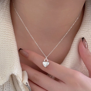 Detail of 925 sterling silver heart necklace with 'for me' engraving and zircon