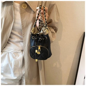 Detail of mini camellia bucket bag with quilted PU leather and gold chain strap