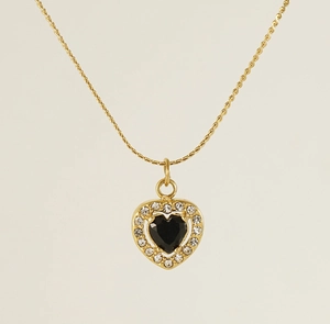 Detail of gold heart necklace with black gemstone center and sparkling zircon halo