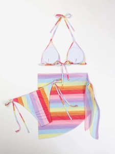 Detailed flat lay of three-piece rainbow stripe bikini set with mesh skirt and pads