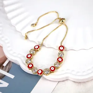 Detail of red enamel evil eye bracelet with cubic zirconia and adjustable slide clasp