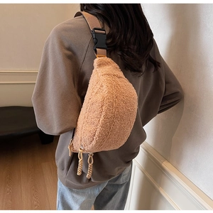 Rear view of model wearing a minimalist light brown plush crossbody chest bag