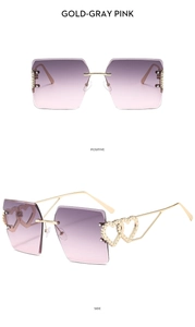 Detail view of rimless square sunglasses with gold heart-shaped hollow out temples