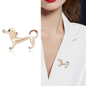 Creative gold dachshund dog brooch pin for clothing accessories on a white suit
