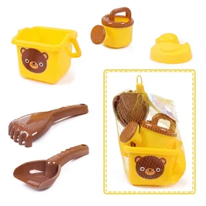 Close-up of yellow bear bucket and plastic beach tools with mesh bag packaging