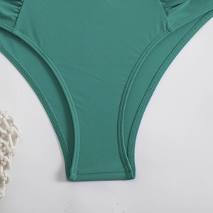 Close-up of dark green bikini bottoms showing high-quality elastic fabric and neat stitching