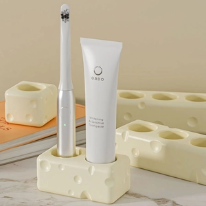 Cheese shaped resin toothbrush holder with multiple holes in creamy yellow finish