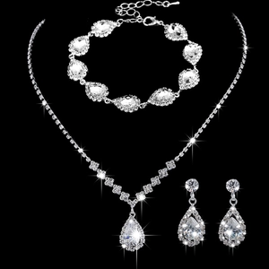 Detailed view of silver bridal jewelry set with sparkling crystals on black background