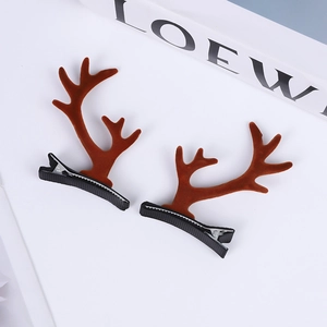 Close-up of brown plush reindeer antler hair clips with metallic duckbill clips