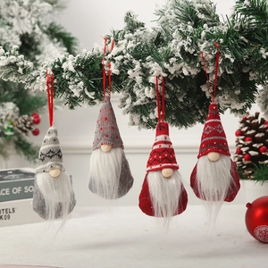 Set of 4 hanging Christmas gnomes with knit hats on a snowy tree branch decoration