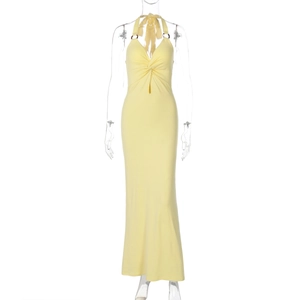 Detail of yellow halter maxi dress featuring waist knot, cut-out and metal ring detail