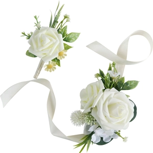 Elegant white rose bridal corsage and boutonniere set with greenery and ribbon