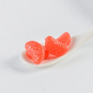 Detailed view of artificial PVC orange slices with realistic texture in a white ceramic spoon