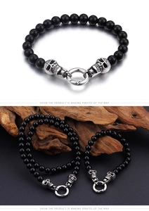 Detail of punk style skull bracelet with black beads and vintage silver metal finish