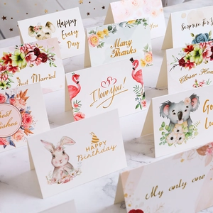 Assorted greeting cards for birthday and wedding on a marble surface backdrop