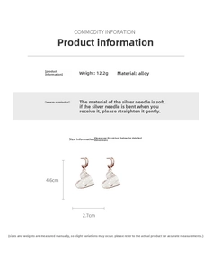 Detail view of silver heart pendant C-hoop earrings with textured hammered finish