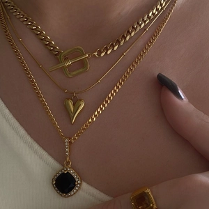 Layered gold heart necklace with OT toggle clasp and black square gemstone pendant details