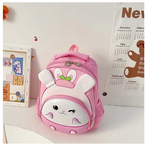 Pink cartoon rabbit backpack with 3D hard shell design and decorative carrot ears for kids