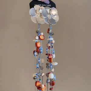Detail of bohemian leaf tassel earrings with colorful beads and 925 silver ear hooks