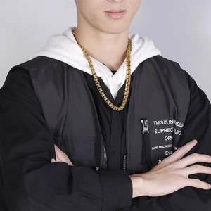 Male model wearing a 7mm gold plated stainless steel box chain necklace over a white hoodie