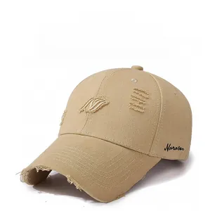 Detail of distressed brim and side embroidery on khaki vintage cotton baseball cap