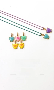 Close-up of heart charm necklaces with 'HUG ME' and 'BE MINE' slogans and braided cords