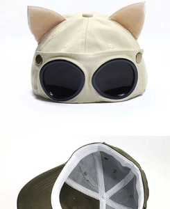 Detail of pilot goggles baseball cap with cat ears in beige and army green fabric
