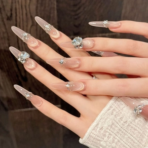 Long stiletto cat eye press-on nails in champagne pink with luxury rhinestone crystals