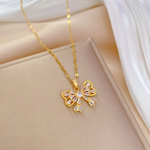 Detail of a gold butterfly necklace with micro-paved zircons on a luxury silk display