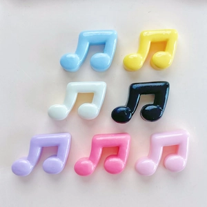Detailed view of colorful resin music note charms for DIY phone cases and hair accessories