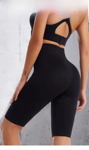Side view of high-waist black seamless fitness shorts and sports bra for women