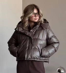 Detail view of deep brown hooded puffer jacket with silk-like glossy finish and warm padding
